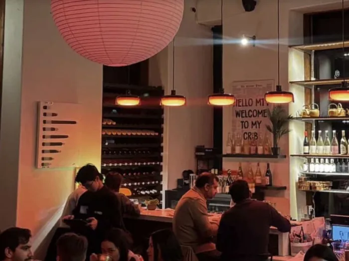 A busy bar lit by a red paper lantern.